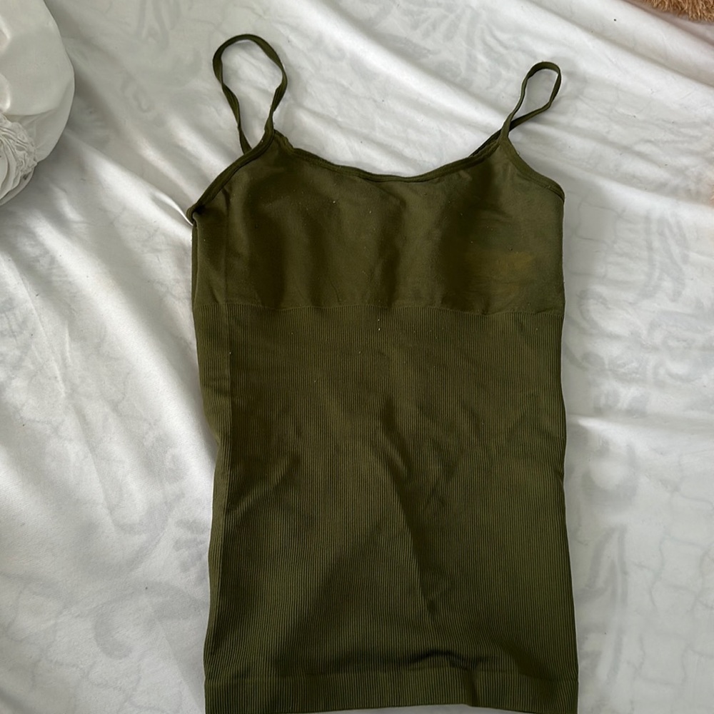 The color is a dark green. If you like a tight shirts. This is for you